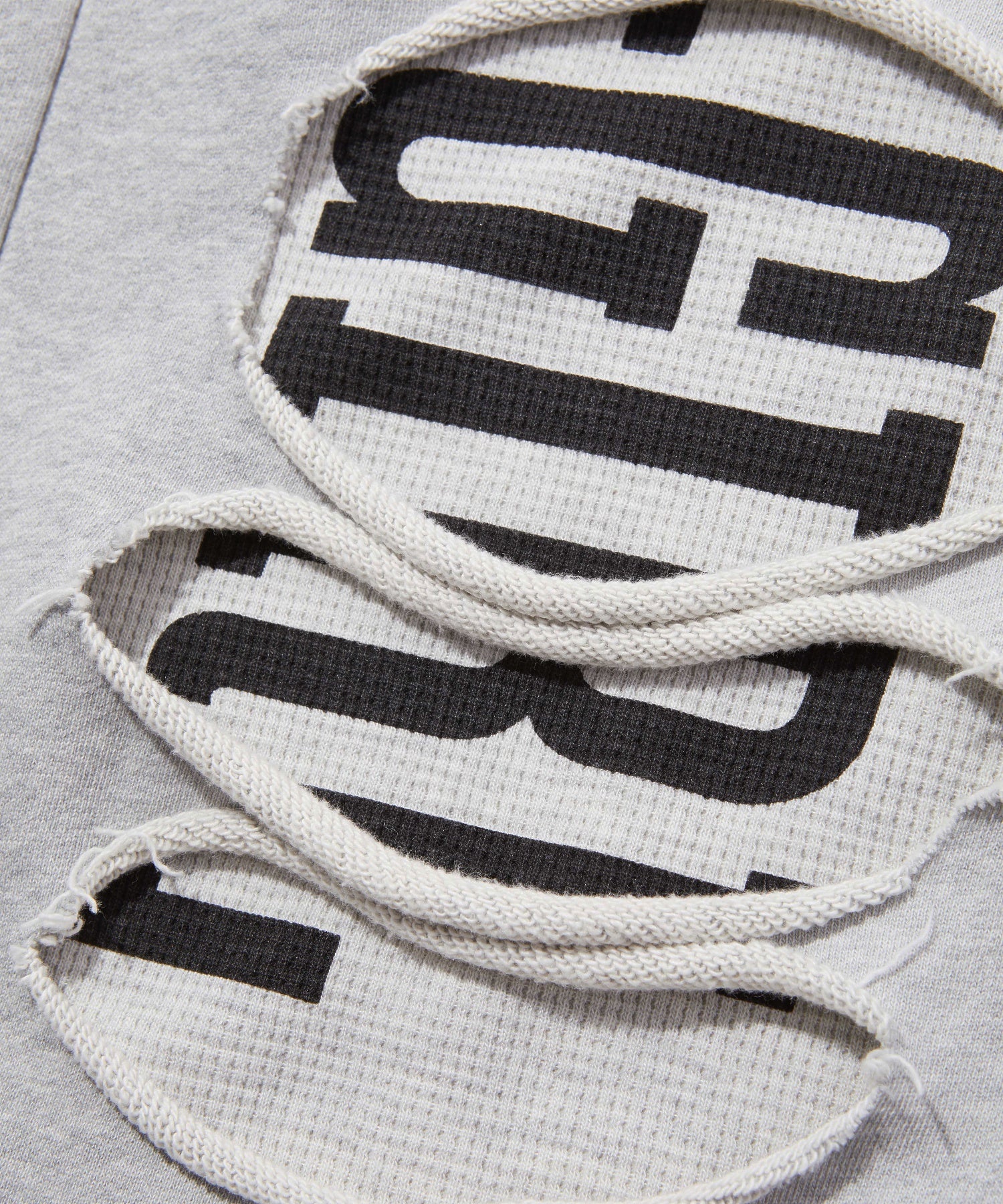 LAYERED DISTRESSED SWEATPANTS